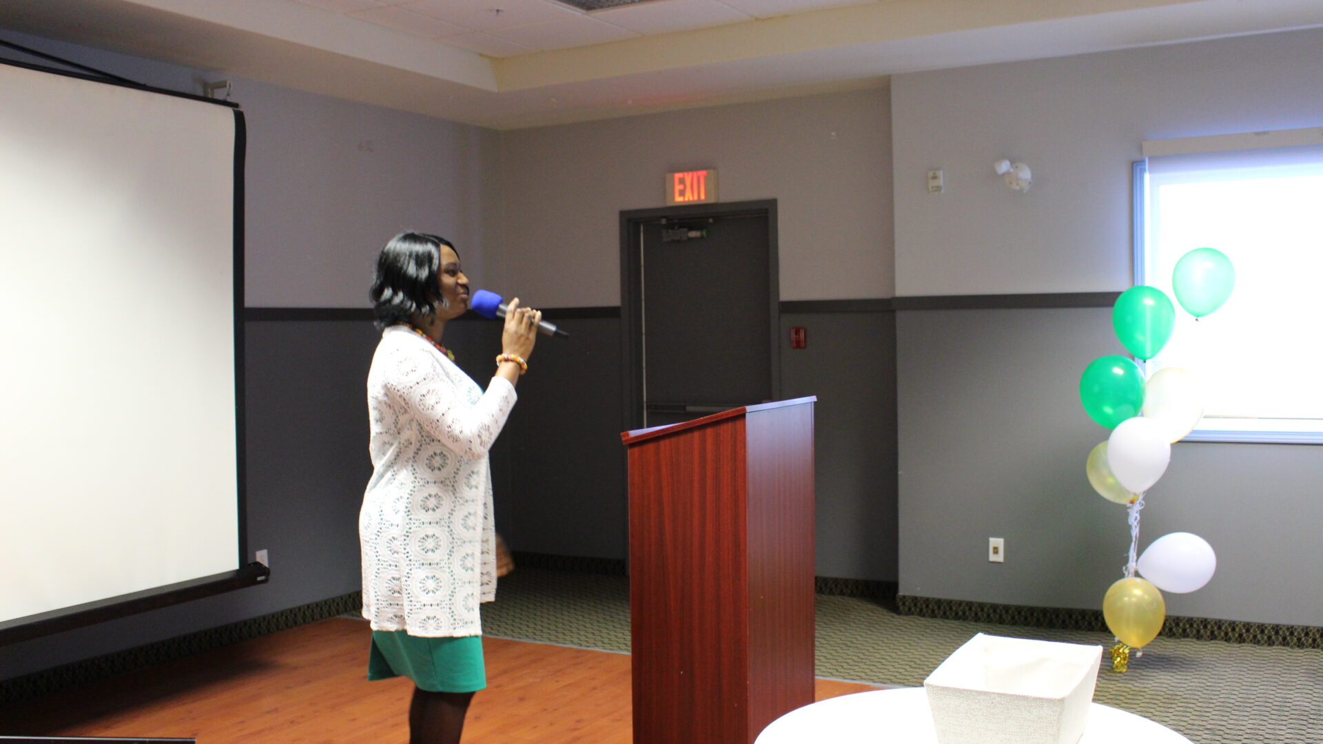 A woman speaking with a microphone